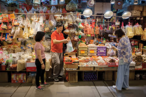 A couple run the stall together in one of Link REIT's fresh market. A couple run the stall together in one of Link REIT's fresh market.